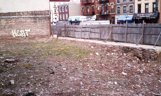 Fencing at 232 Smith is falling apart and illegally placed on the sidewalk.